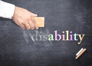 disability written in chalk with a hand erasing "dis" from the front of the word