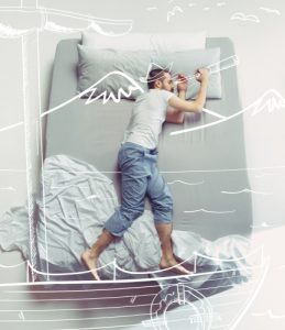 man dreaming on a bed